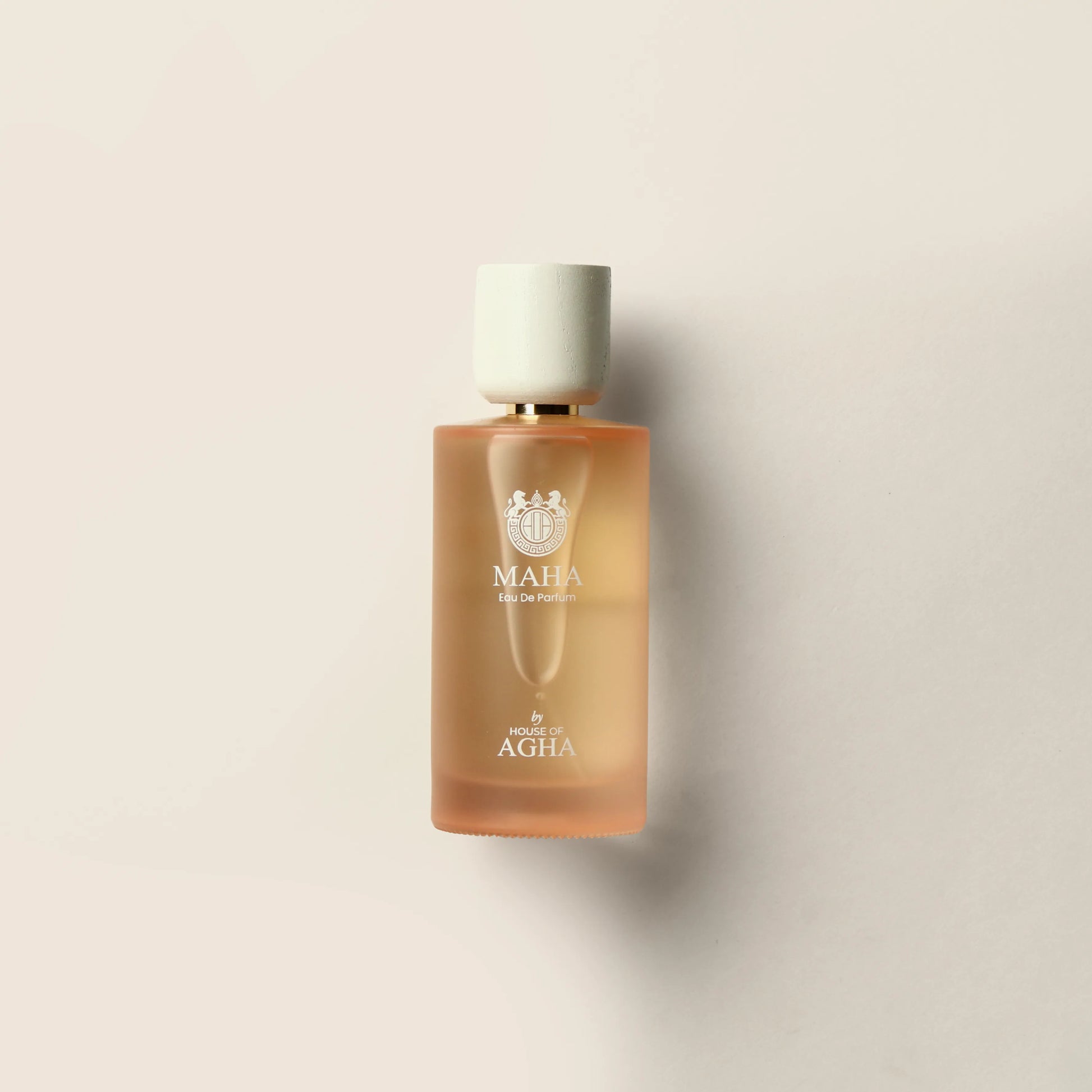 Perfume bottle with a white cap on a beige background