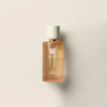 Perfume bottle with a white cap on a beige background