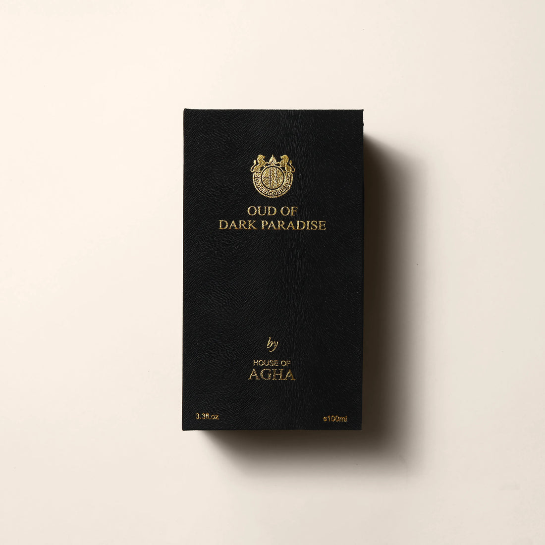 Black box with gold text and logo on a beige background